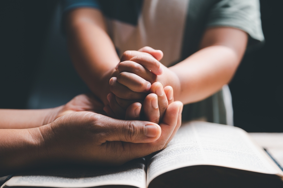 Adult and child praying